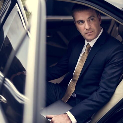 executive leaving corporate limousine