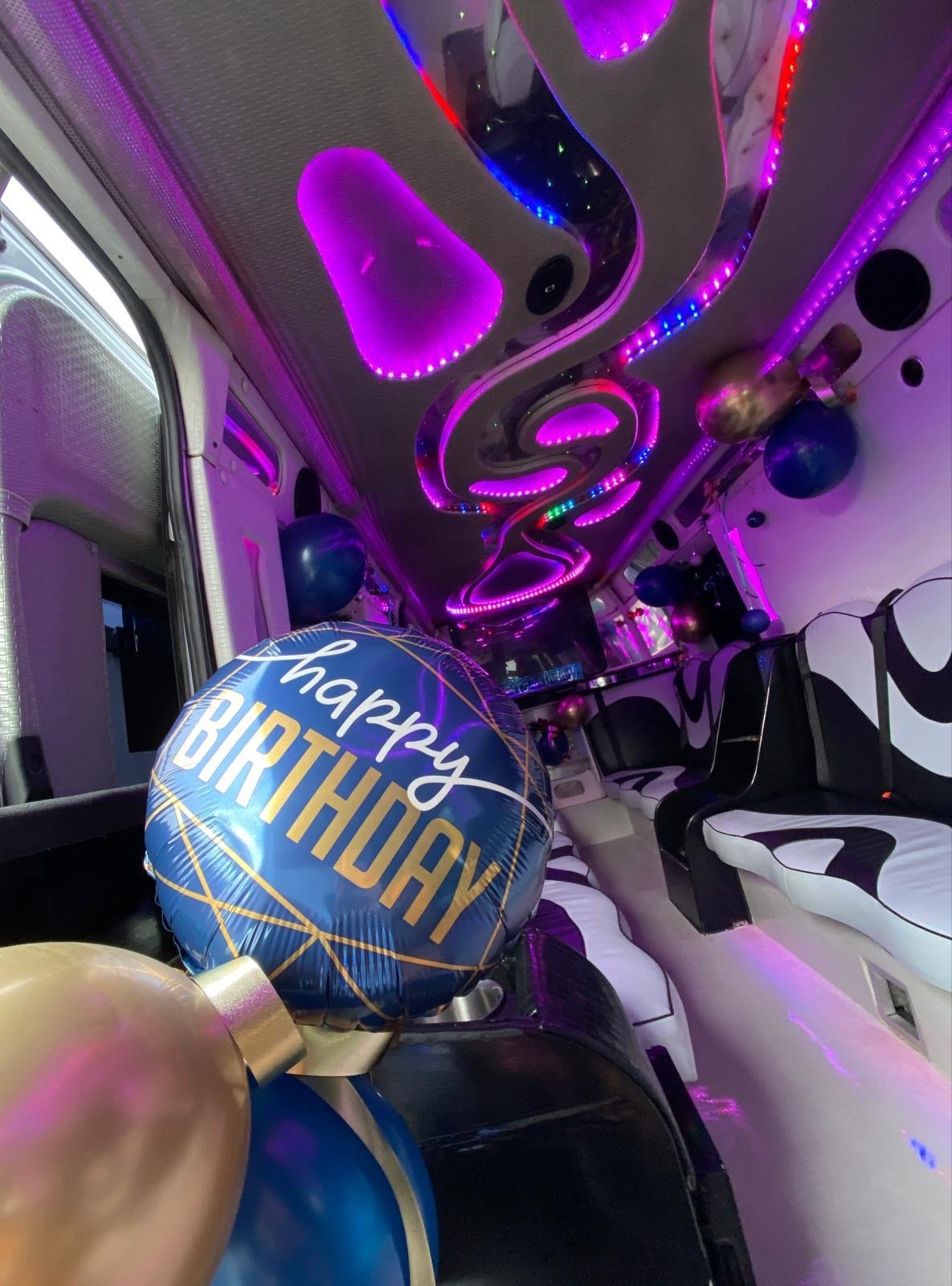 inside party bus with birthday balloons decorations