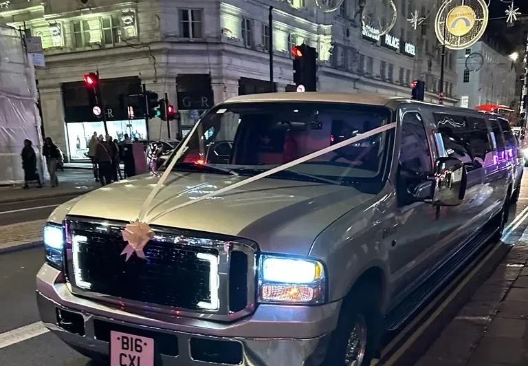 ford excursion limo with wedding ribbons in London city