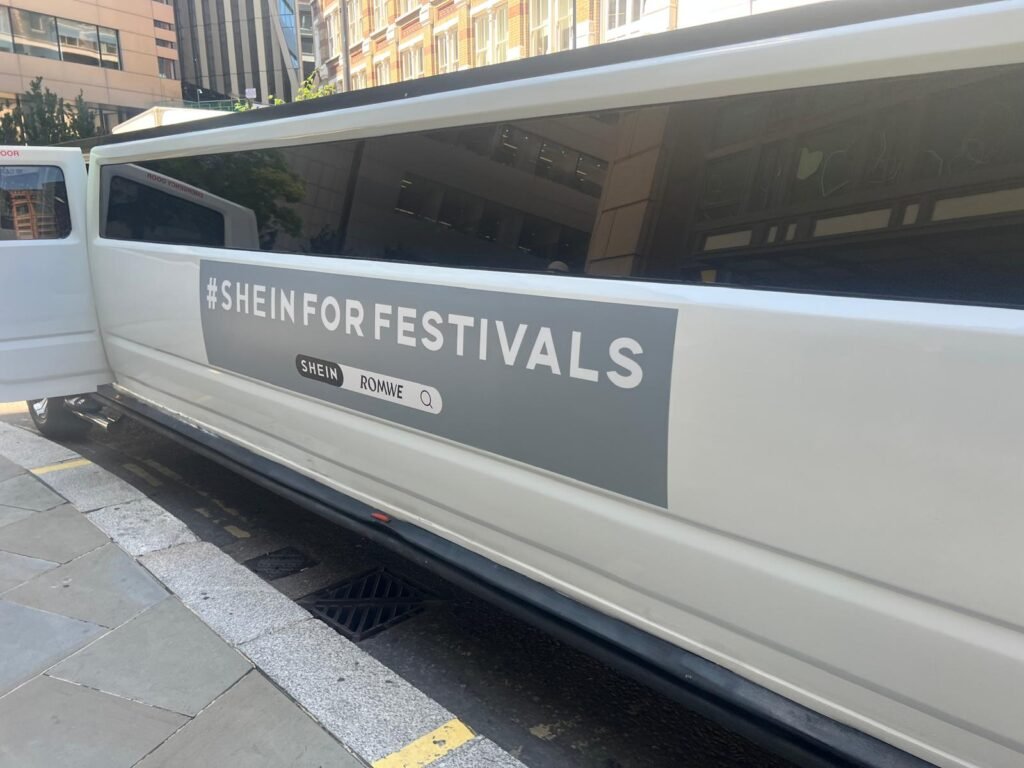 Temporary SHEIN festival graphics fitted to the side of a Hummer H2 limousine