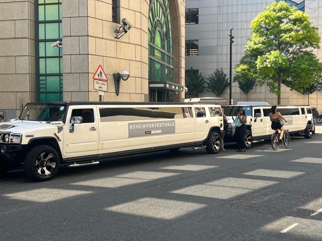 Close view of temporary SHEIN branding applied to a white Hummer H2 limousine